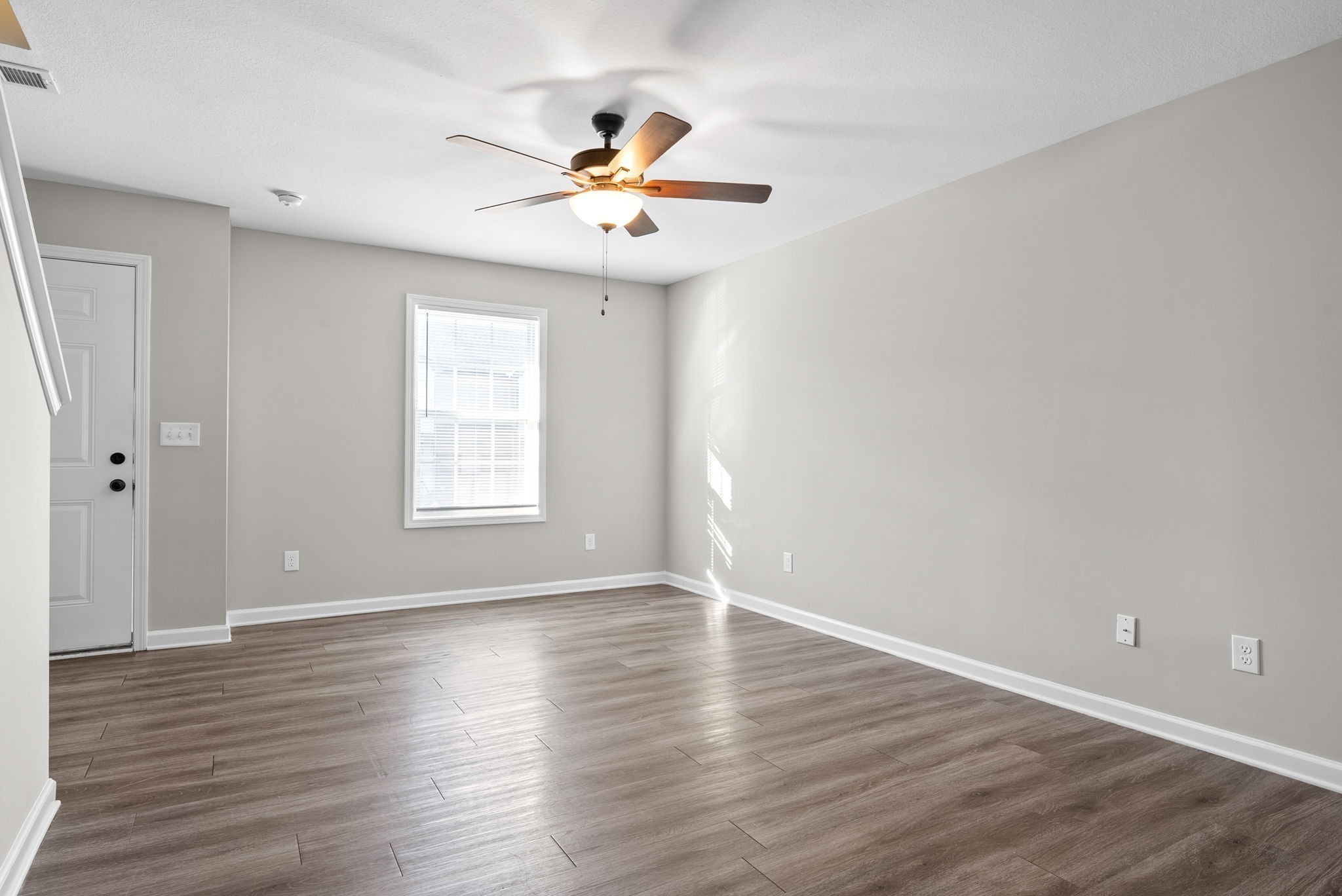 264 Smithson Lane, Unit B Clarksville, TN 37040 - Photo 8 of 25 a view of an empty room with wooden floor and a window