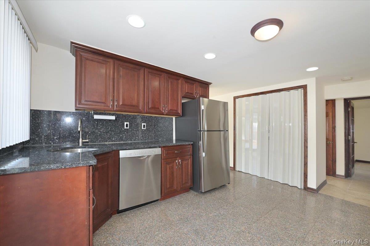 9 Cabot Road West Massapequa, NY 11758 - Photo 16 of 41 a kitchen with stainless steel appliances granite countertop a refrigerator a sink and a stove
