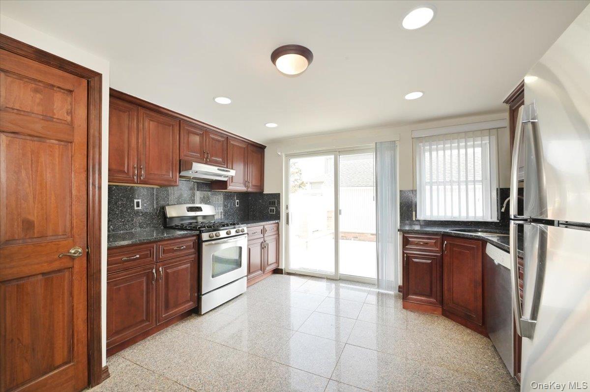 9 Cabot Road West Massapequa, NY 11758 - Photo 18 of 41 a kitchen with stainless steel appliances granite countertop a refrigerator stove and sink