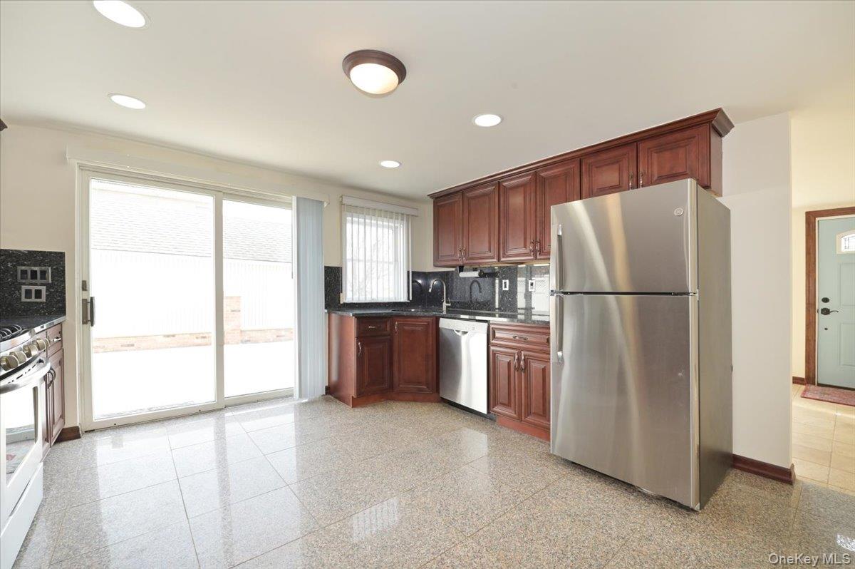 9 Cabot Road West Massapequa, NY 11758 - Photo 19 of 41 a kitchen with a refrigerator and a sink