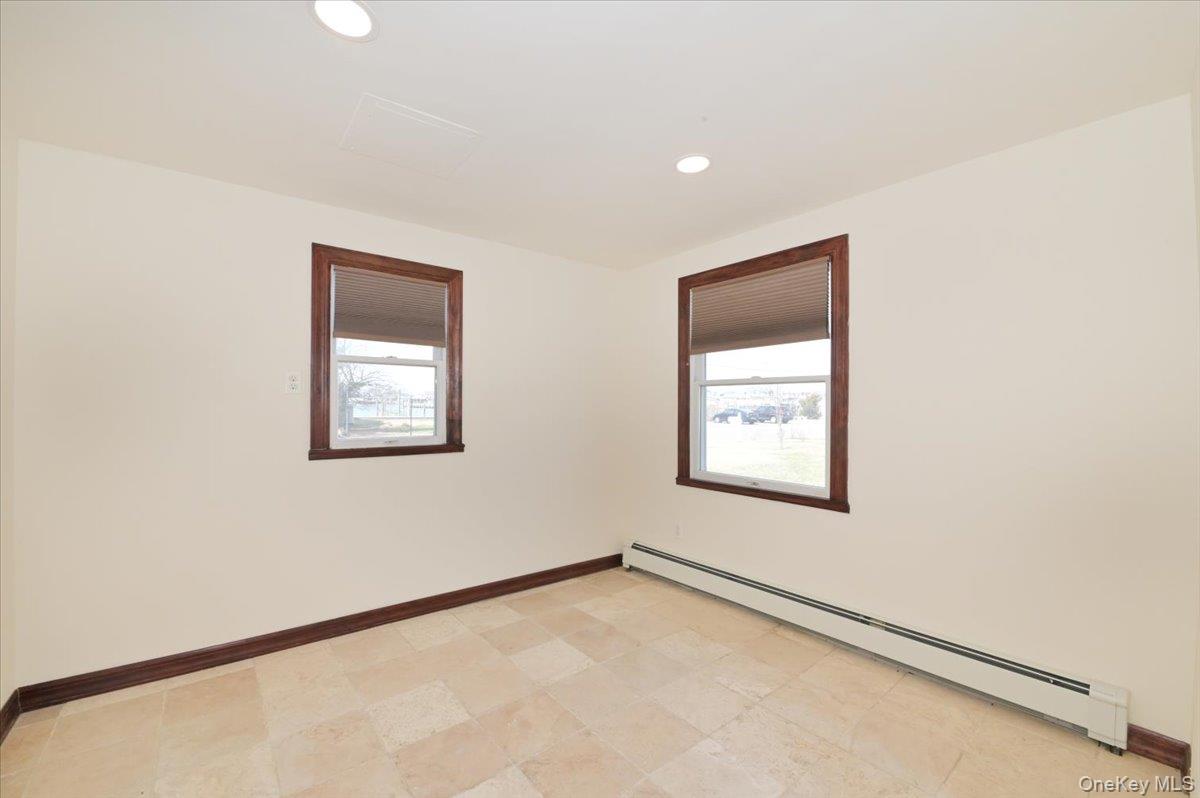 9 Cabot Road West Massapequa, NY 11758 - Photo 20 of 41 a view of an empty room with a window
