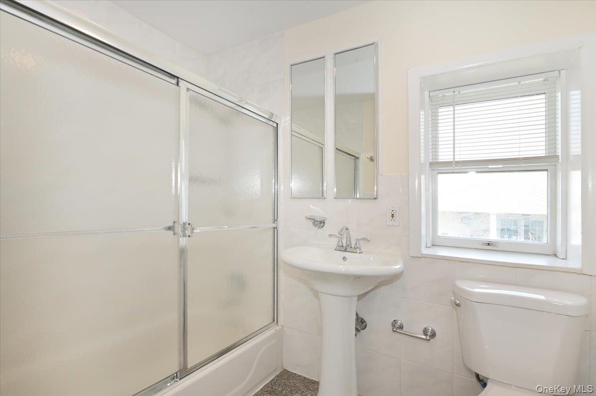 9 Cabot Road West Massapequa, NY 11758 - Photo 28 of 41 a bathroom with a sink toilet and shower