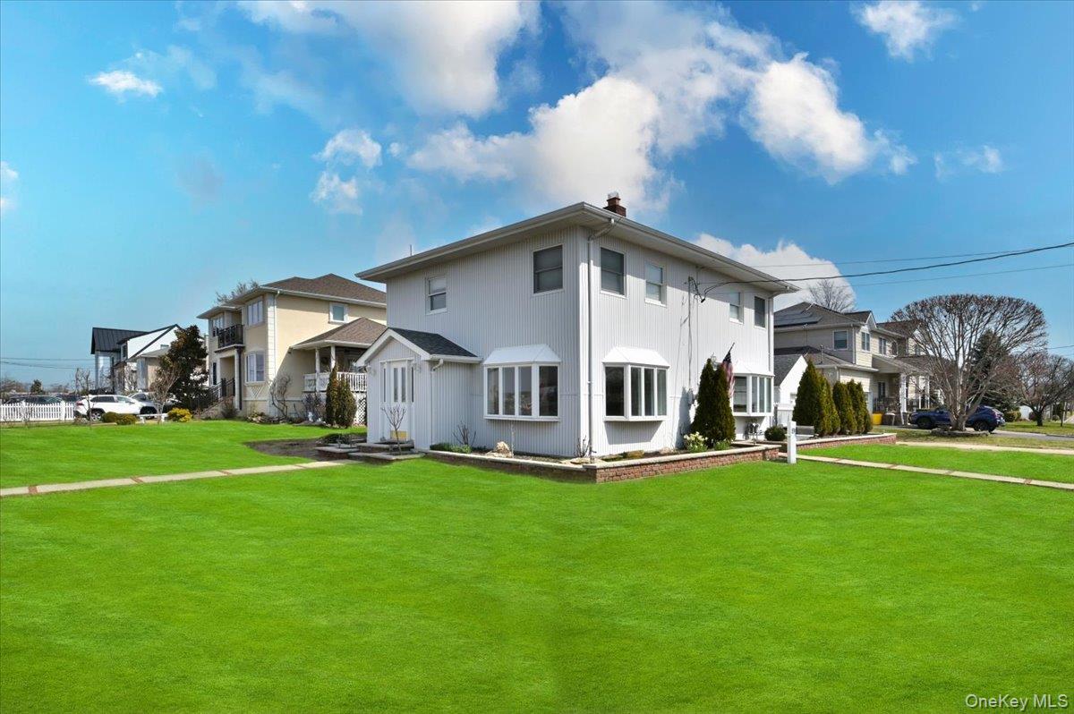 9 Cabot Road West Massapequa, NY 11758 - Photo 3 of 41 a front view of a house with a yard