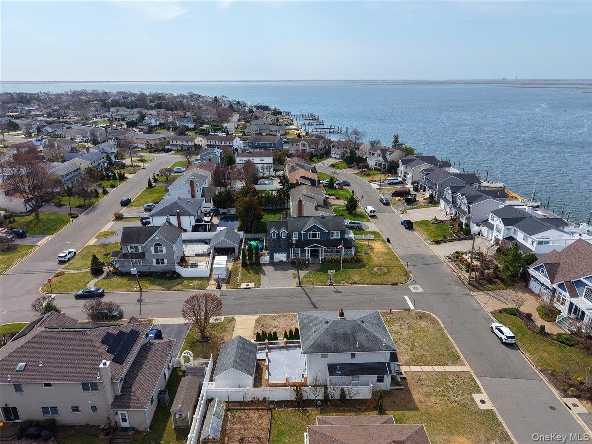 9 Cabot Road West Massapequa, NY 11758 - Photo 39 of 41 an aerial view of a city with lots of residential buildings and ocean view in back