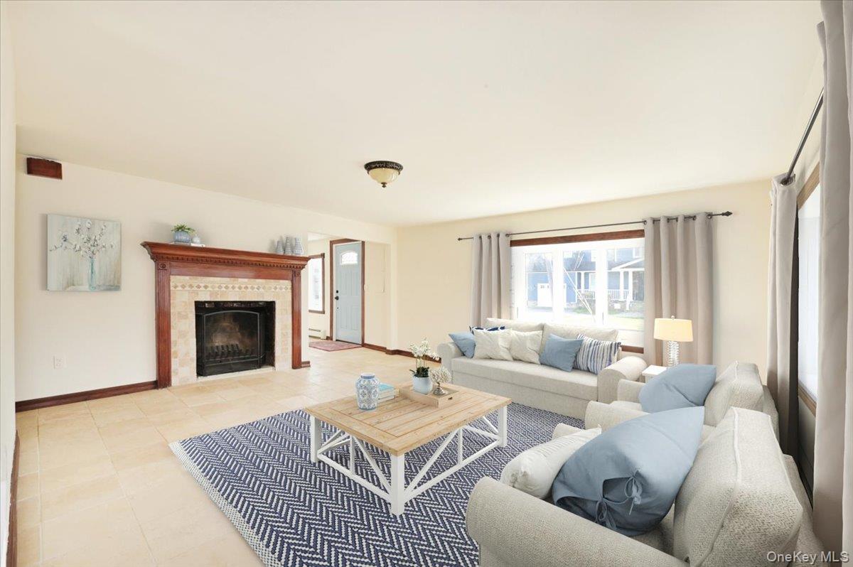 9 Cabot Road West Massapequa, NY 11758 - Photo 9 of 41 a living room with furniture and a fireplace