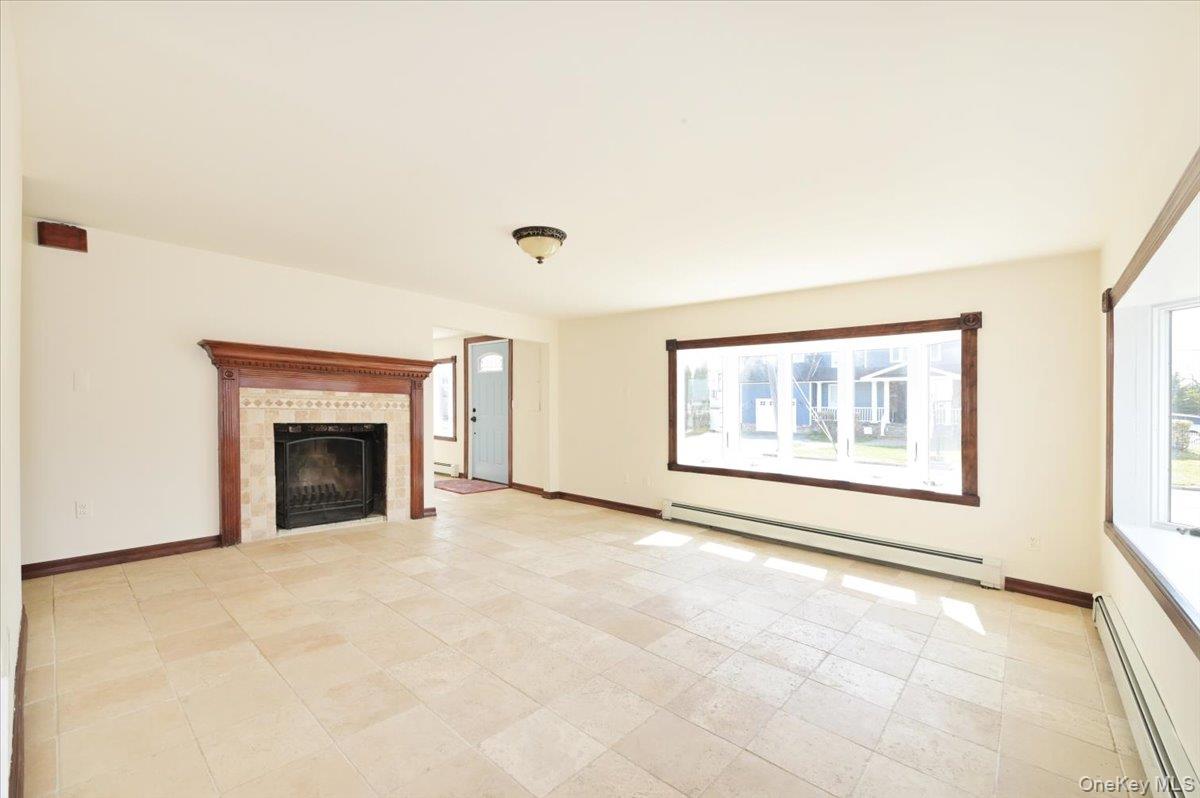 9 Cabot Road West Massapequa, NY 11758 - Photo 10 of 41 an empty room with windows and fireplace