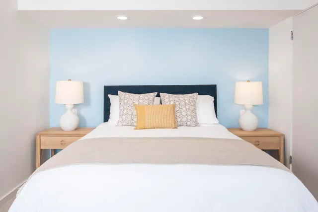 a bedroom with a bed and a lamp