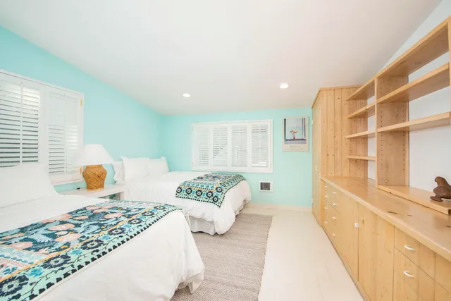 a bedroom with furniture and a large window