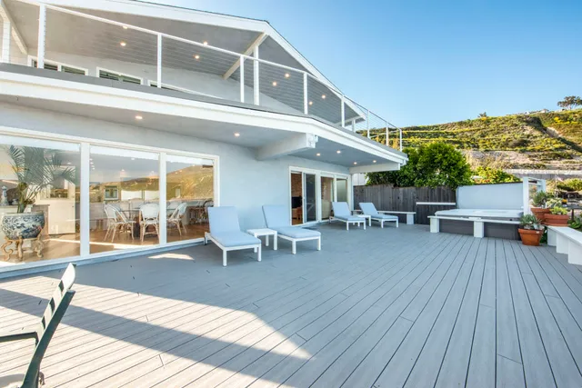 a view of a patio with table and chairs and wooden floor