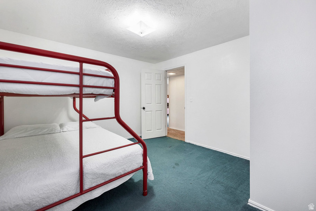 3334 Ute Road St. George, UT 84790 - Photo 30 of 40 Unfurnished bedroom with dark carpet and a textured ceiling