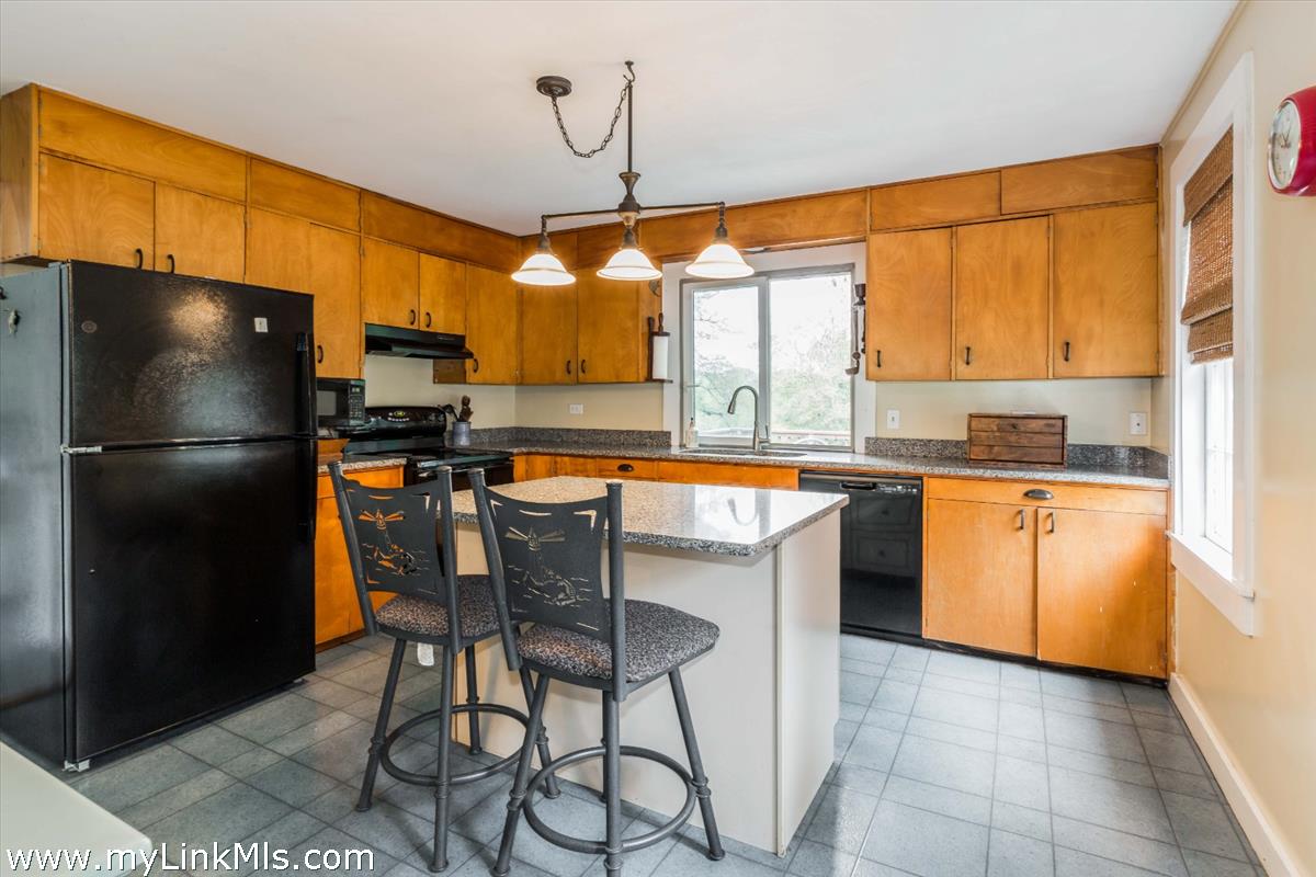 986 State Road Vineyard Haven, MA 02568 - Photo 12 of 27 a kitchen with stainless steel appliances granite countertop a refrigerator a sink dishwasher a stove and a microwave oven