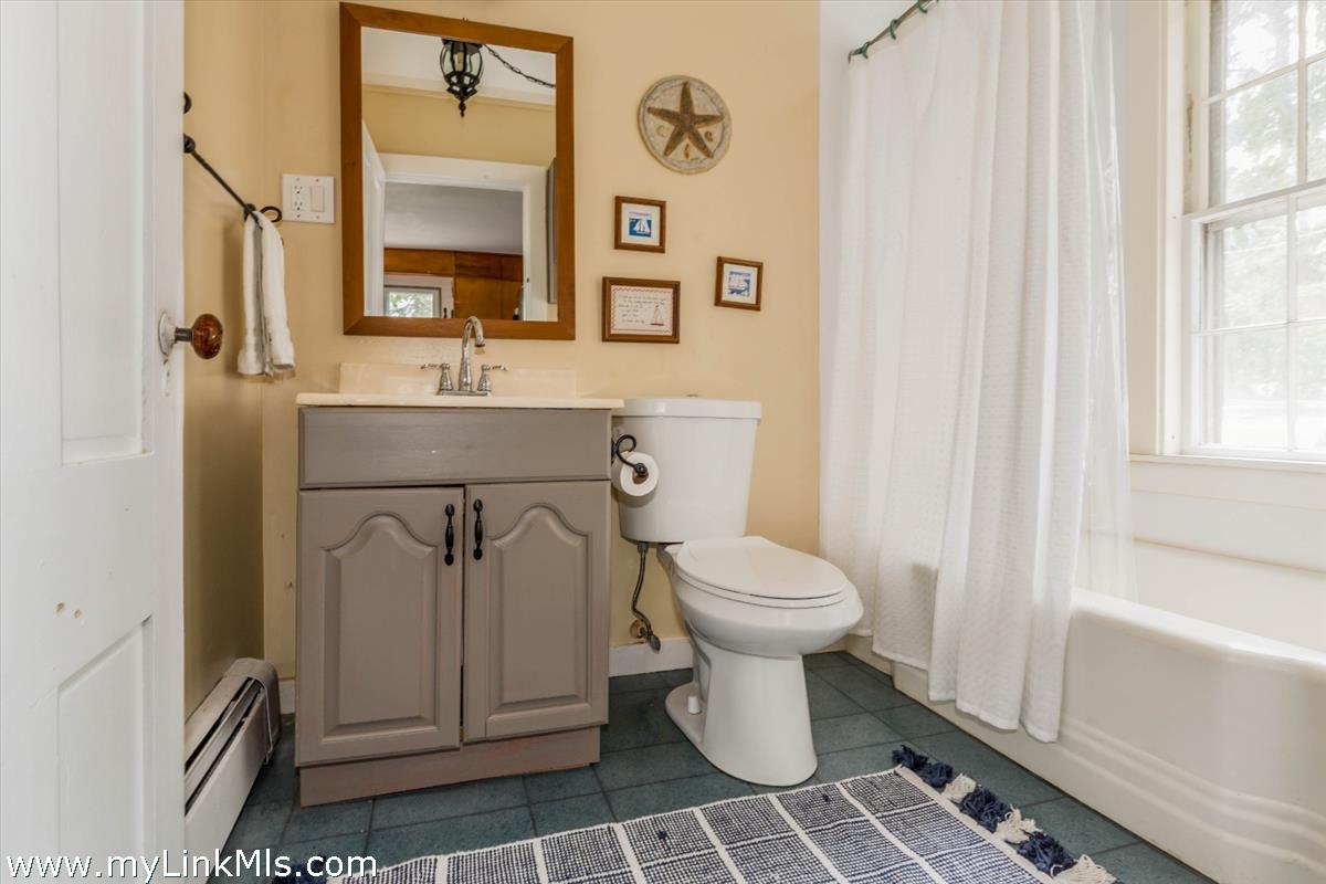 986 State Road Vineyard Haven, MA 02568 - Photo 14 of 27 a white toilet sitting next to a bathroom sink