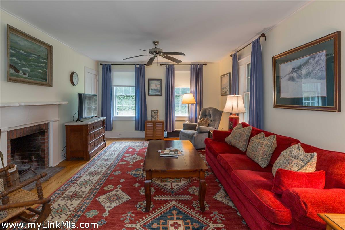 986 State Road Vineyard Haven, MA 02568 - Photo 16 of 27 a living room with furniture a flat screen tv and a fireplace