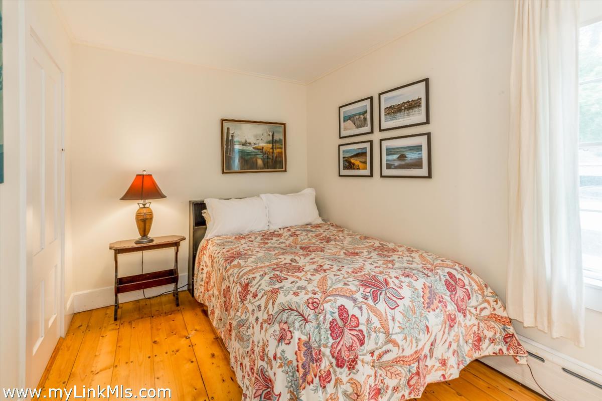 986 State Road Vineyard Haven, MA 02568 - Photo 17 of 27 a bedroom with a bed and a painting on the wall
