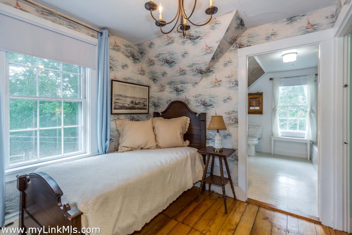 986 State Road Vineyard Haven, MA 02568 - Photo 18 of 27 a bedroom with a bed and wooden floor