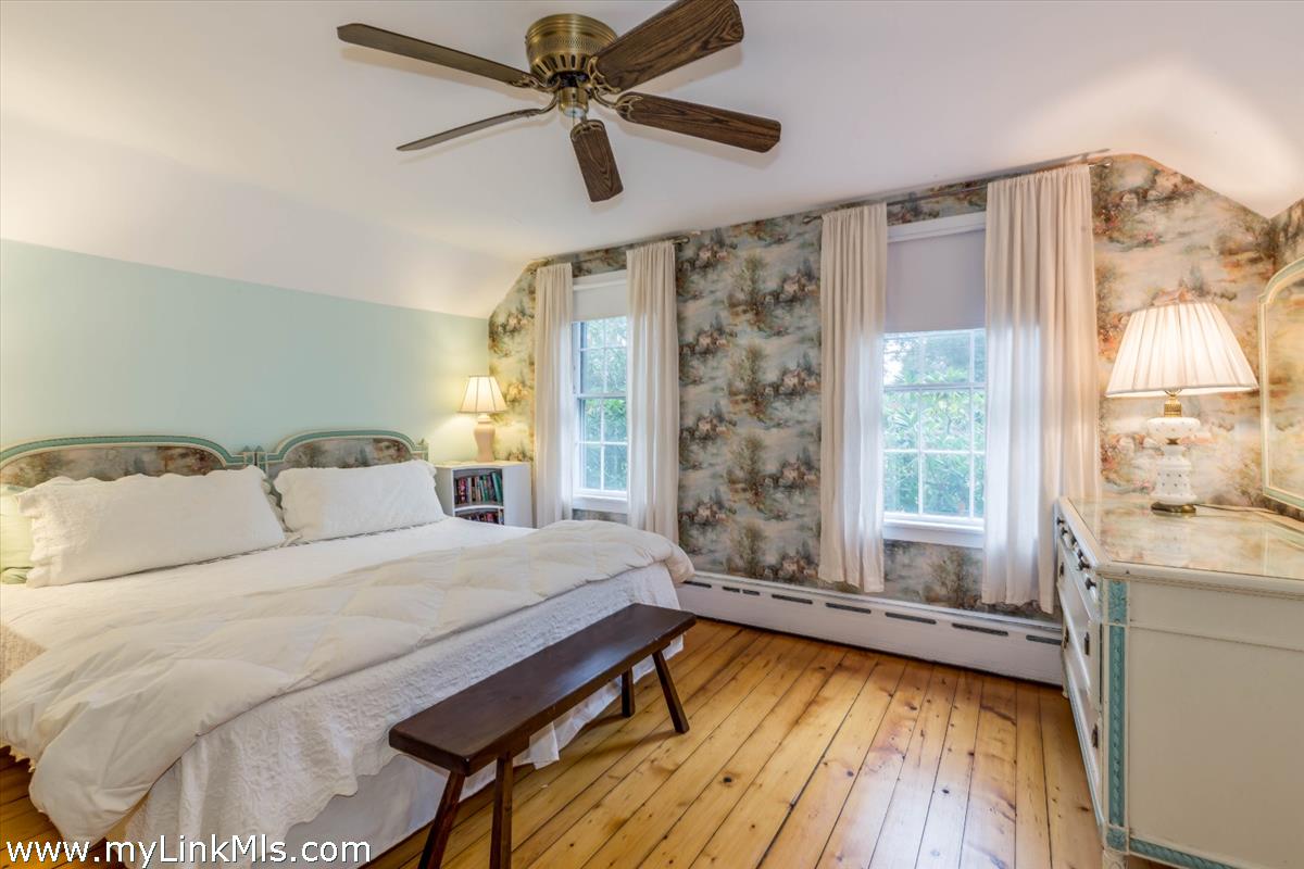 986 State Road Vineyard Haven, MA 02568 - Photo 19 of 27 a spacious bedroom with a large bed and a window