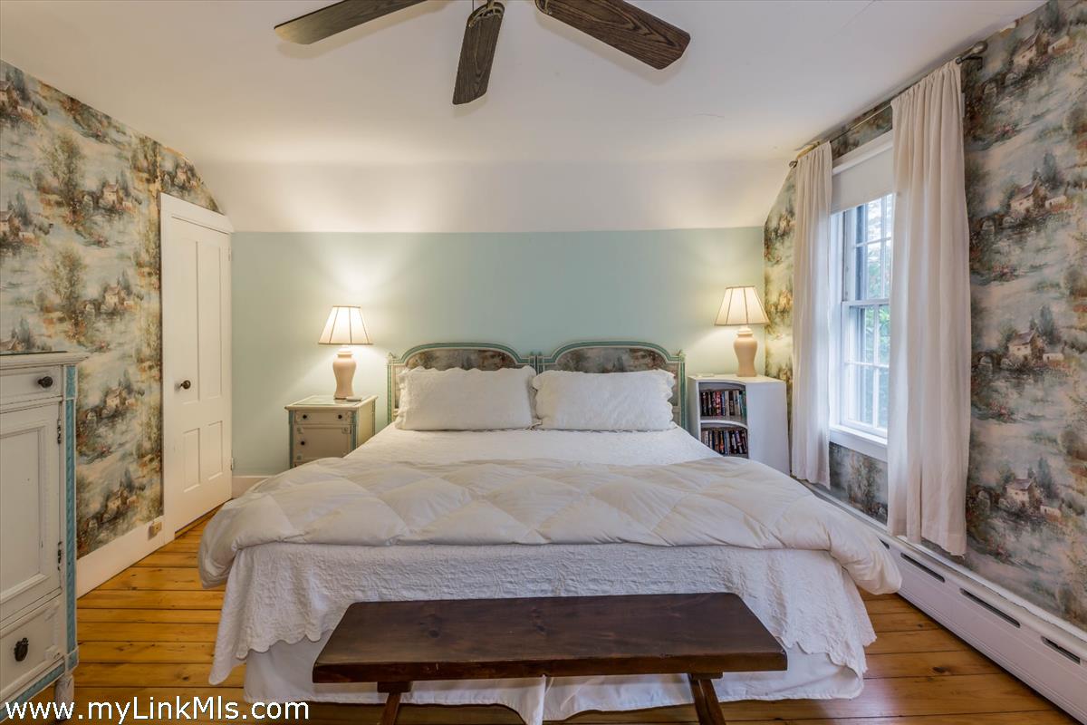986 State Road Vineyard Haven, MA 02568 - Photo 20 of 27 a bedroom with a bed and wooden floor