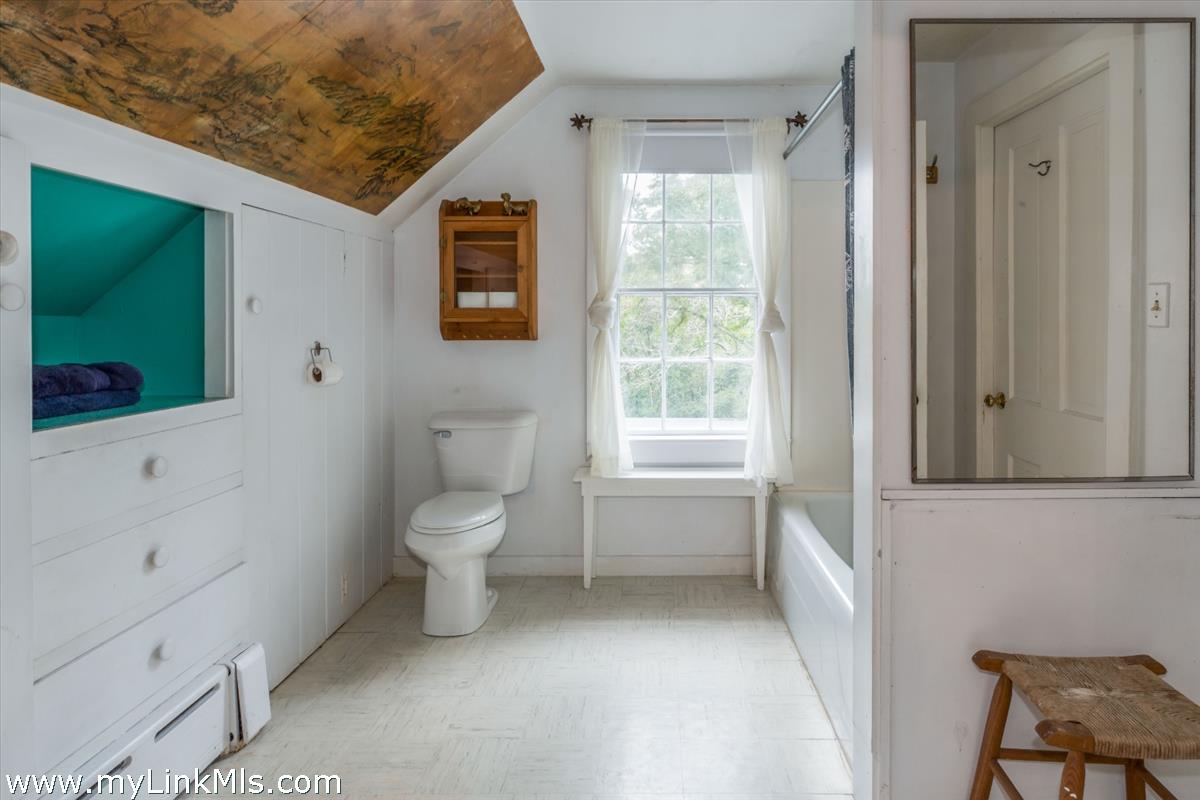 986 State Road Vineyard Haven, MA 02568 - Photo 22 of 27 a bathroom with a toilet sink and mirror