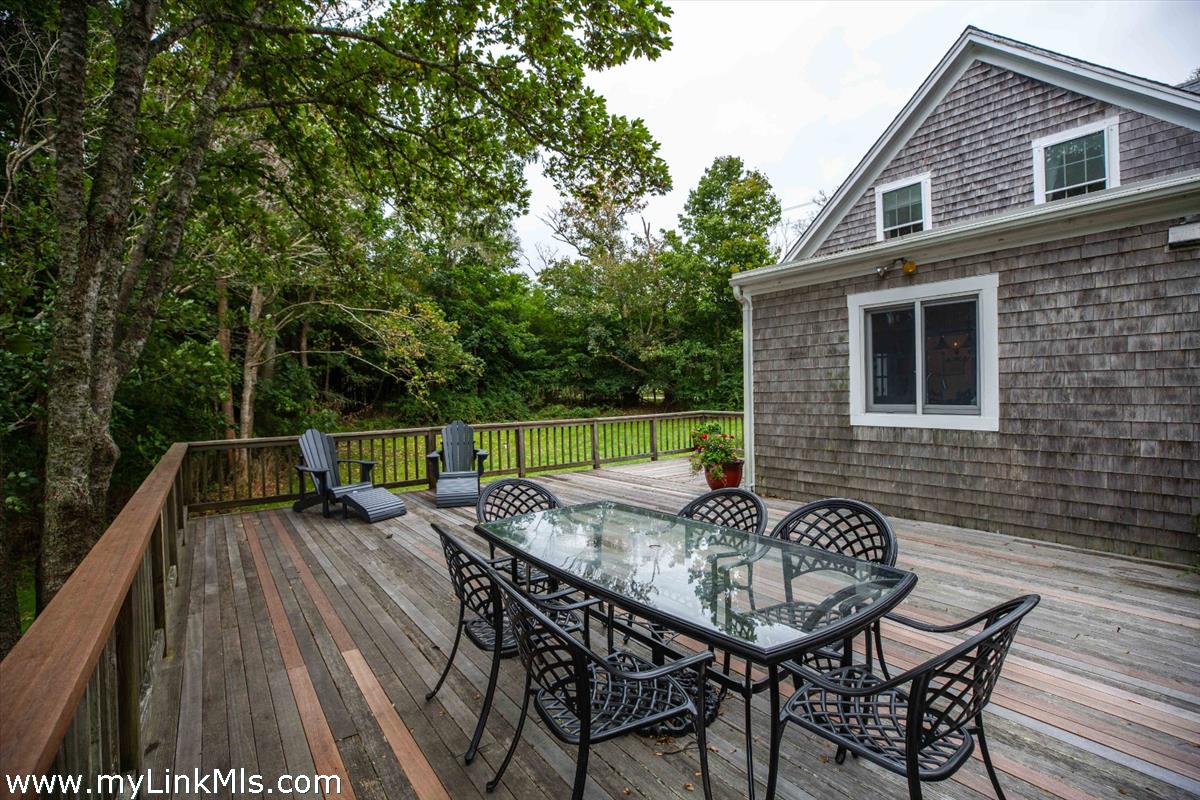 986 State Road Vineyard Haven, MA 02568 - Photo 9 of 27 a view of deck with table and chairs and wooden floor