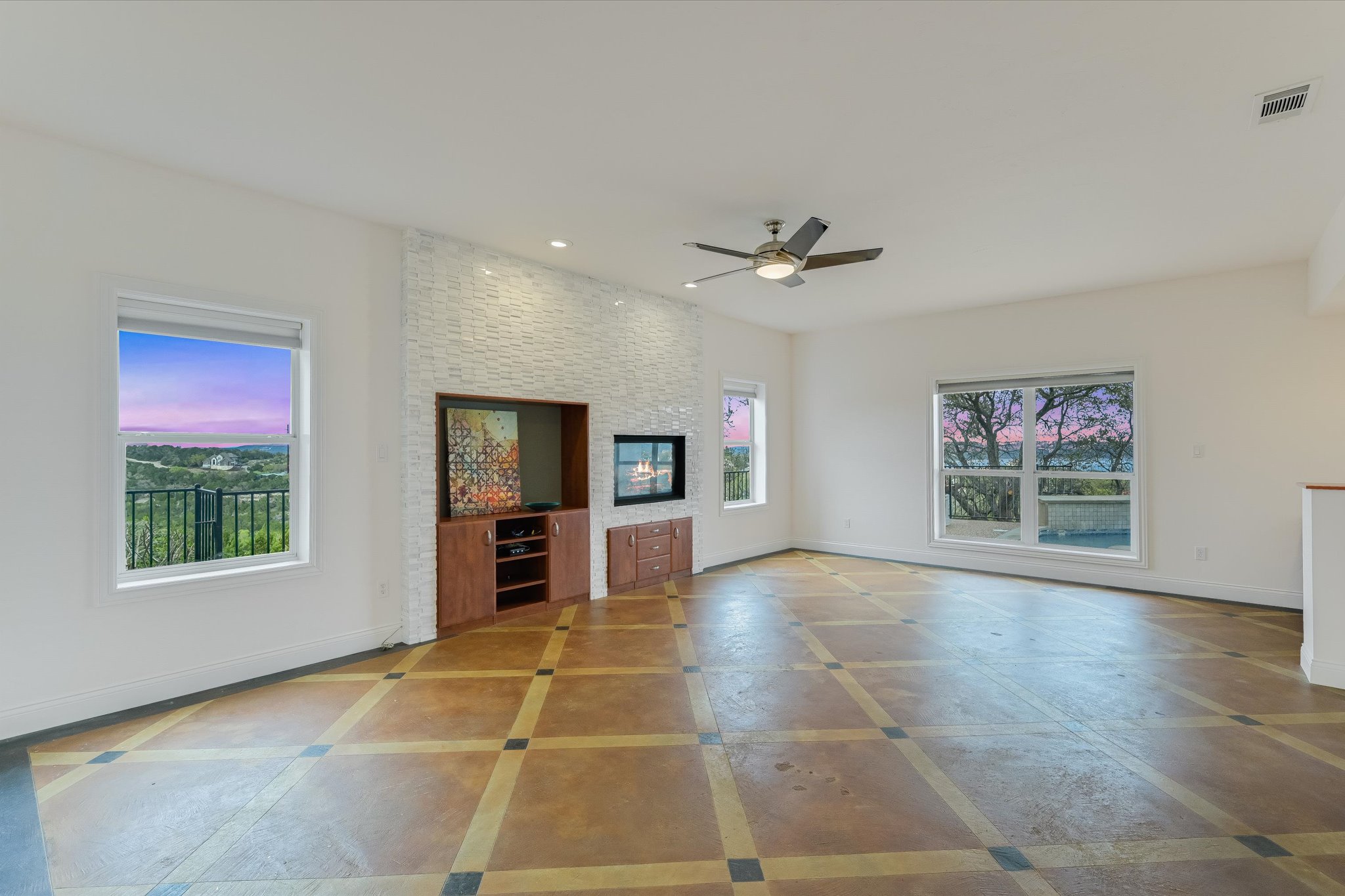 4319 Rum Runner Road Austin, TX 78734 - Photo 32 of 40 Unfurnished living room with ceiling fan, recessed lighting, and a large fireplace