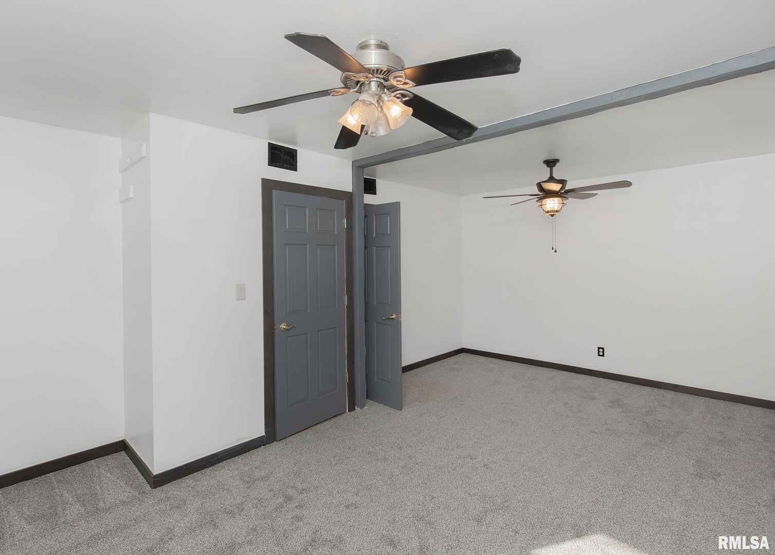 444 6th Street East Milan, IL 61264 - Photo 13 of 26 an empty room with closet and a ceiling fan