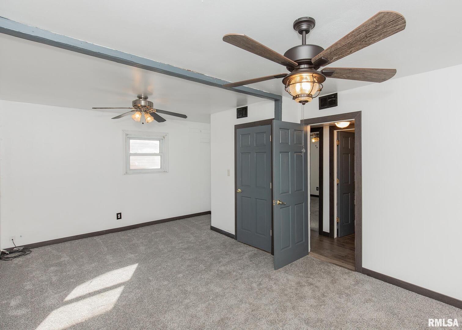 444 6th Street East Milan, IL 61264 - Photo 14 of 26 an empty room with windows and fan