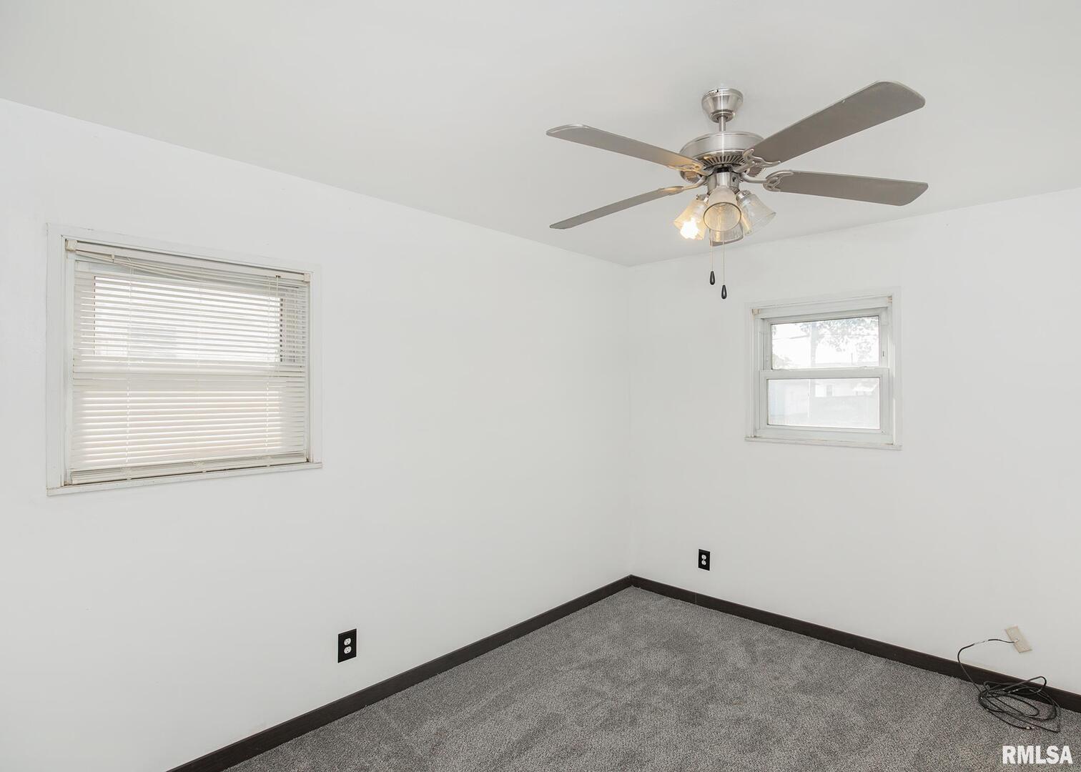 444 6th Street East Milan, IL 61264 - Photo 15 of 26 an empty room with a window and a fan