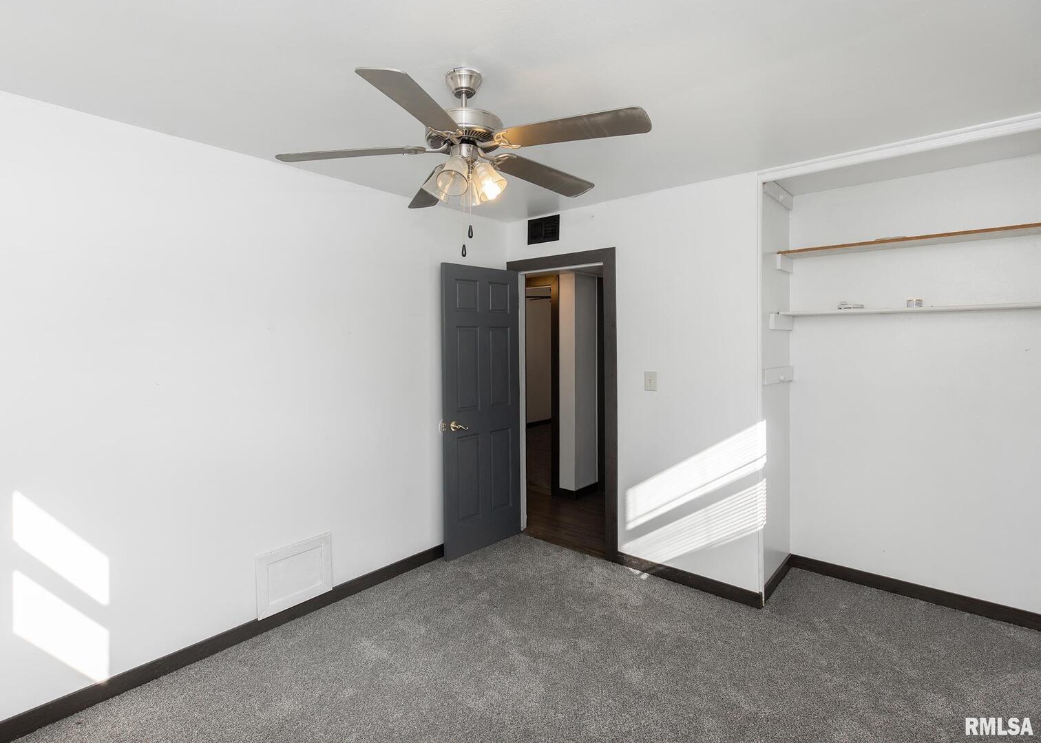 444 6th Street East Milan, IL 61264 - Photo 16 of 26 an empty room with closet and a ceiling fan