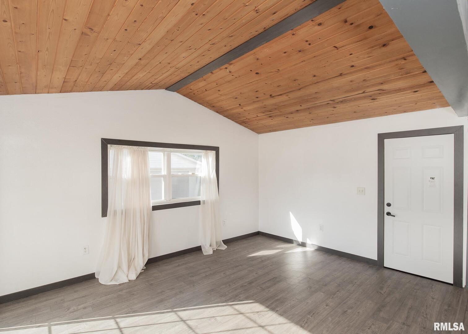 444 6th Street East Milan, IL 61264 - Photo 10 of 26 an empty room with wooden floor cabinet and windows