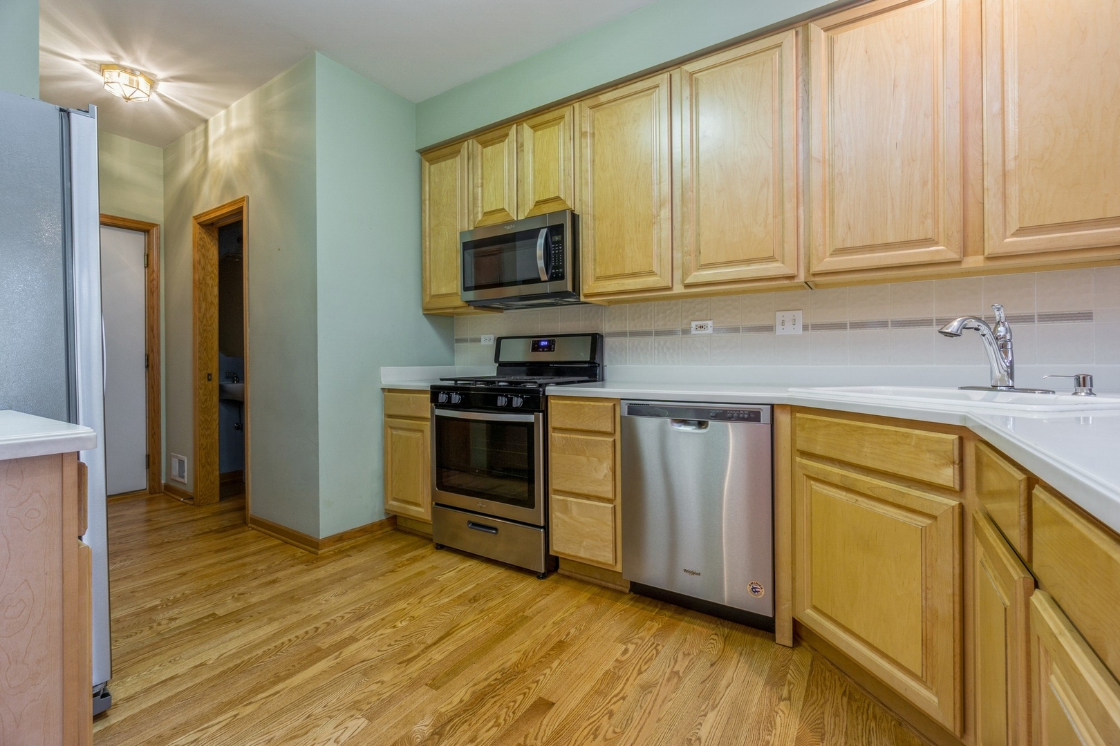 1711 Park Ridge Point Park Ridge, IL 60068 - Photo 6 of 16 a kitchen with stainless steel appliances granite countertop a stove a sink and a refrigerator