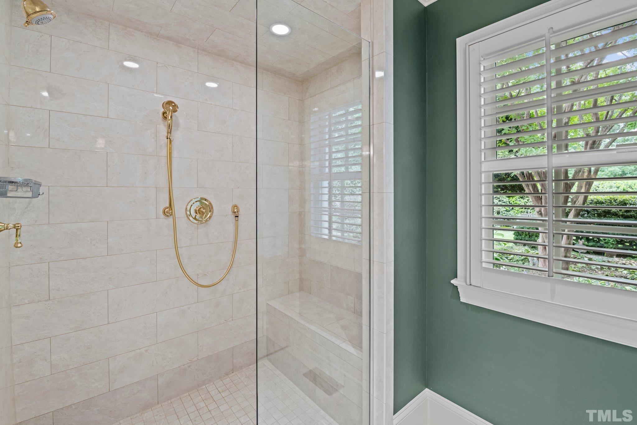 2217 St Marys Street Raleigh, NC 27608 - Photo 20 of 52 a bathroom with a glass shower door and a sink