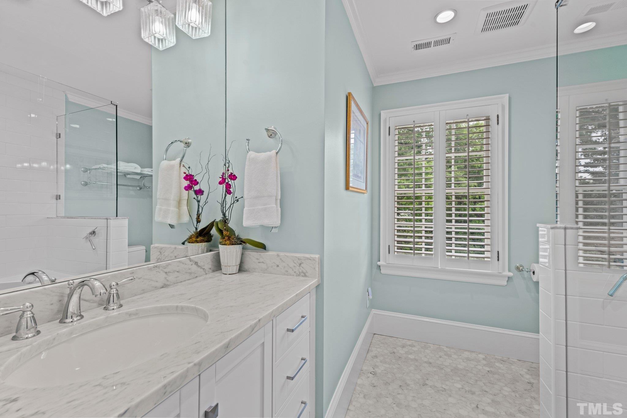 2217 St Marys Street Raleigh, NC 27608 - Photo 30 of 52 a bathroom with a granite countertop sink a shower and a mirror