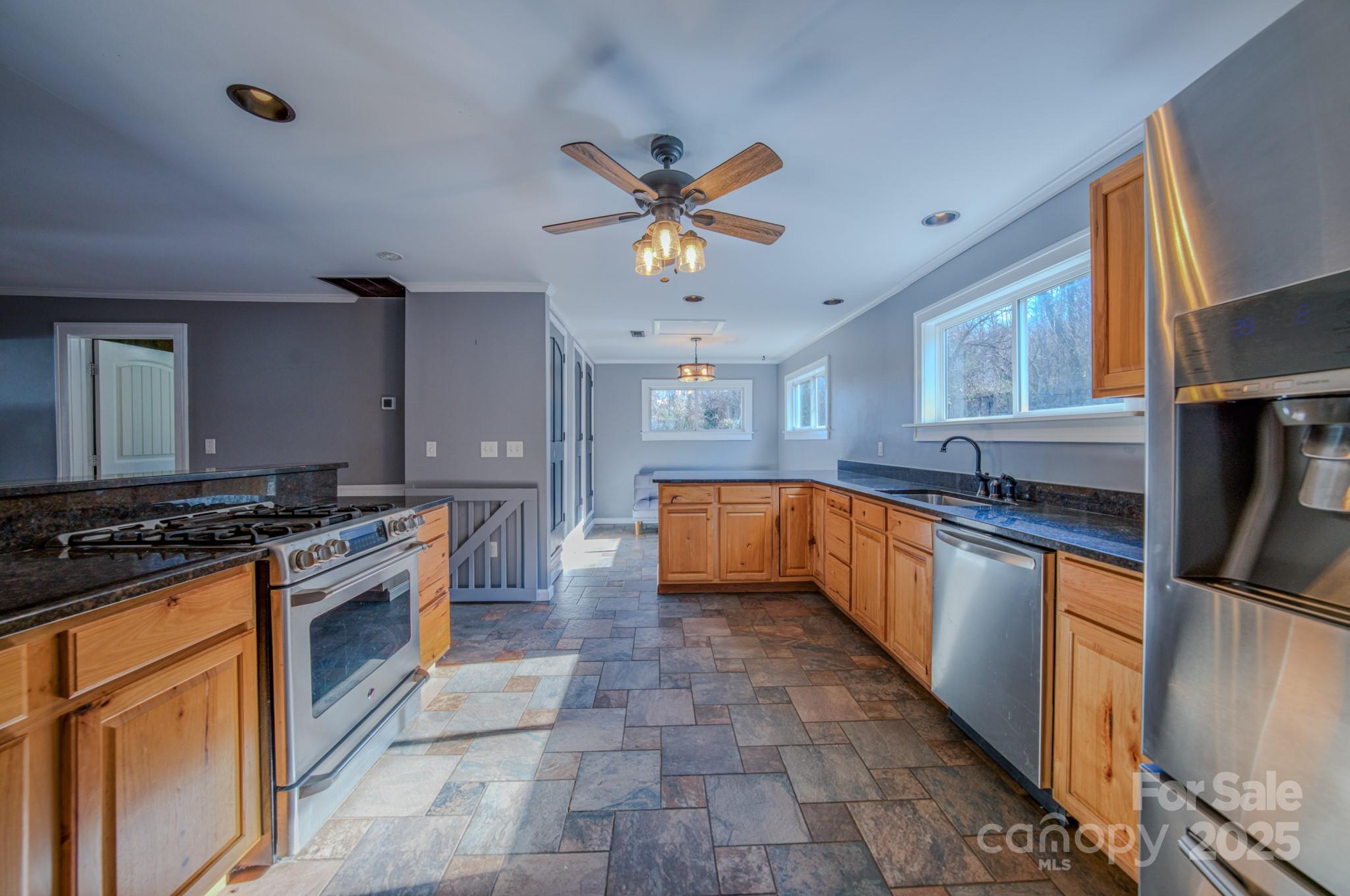 206 Martin Road Swannanoa, NC 28778 - Photo 14 of 42 a kitchen with stainless steel appliances granite countertop a stove a sink and a refrigerator