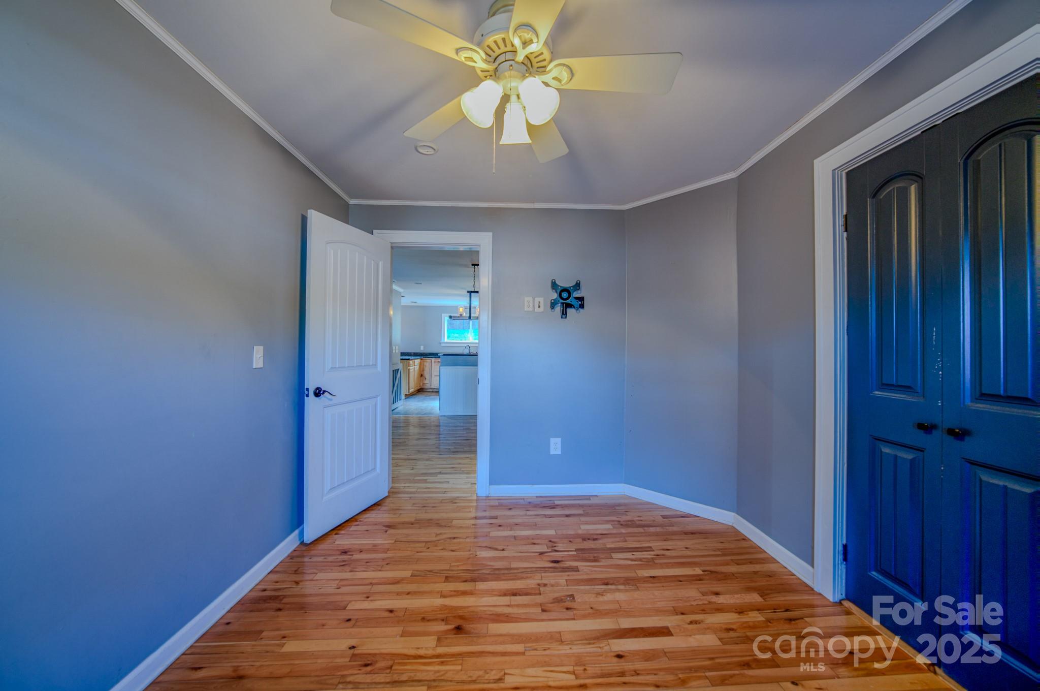 206 Martin Road Swannanoa, NC 28778 - Photo 22 of 42 a bedroom with a bed and a chandelier fan
