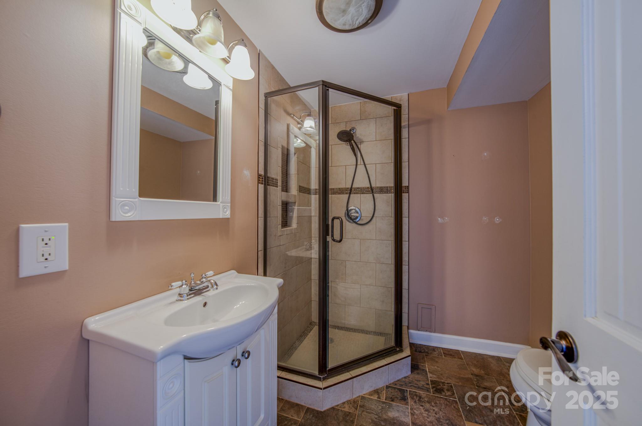 206 Martin Road Swannanoa, NC 28778 - Photo 27 of 42 a bathroom with a sink mirror and vanity