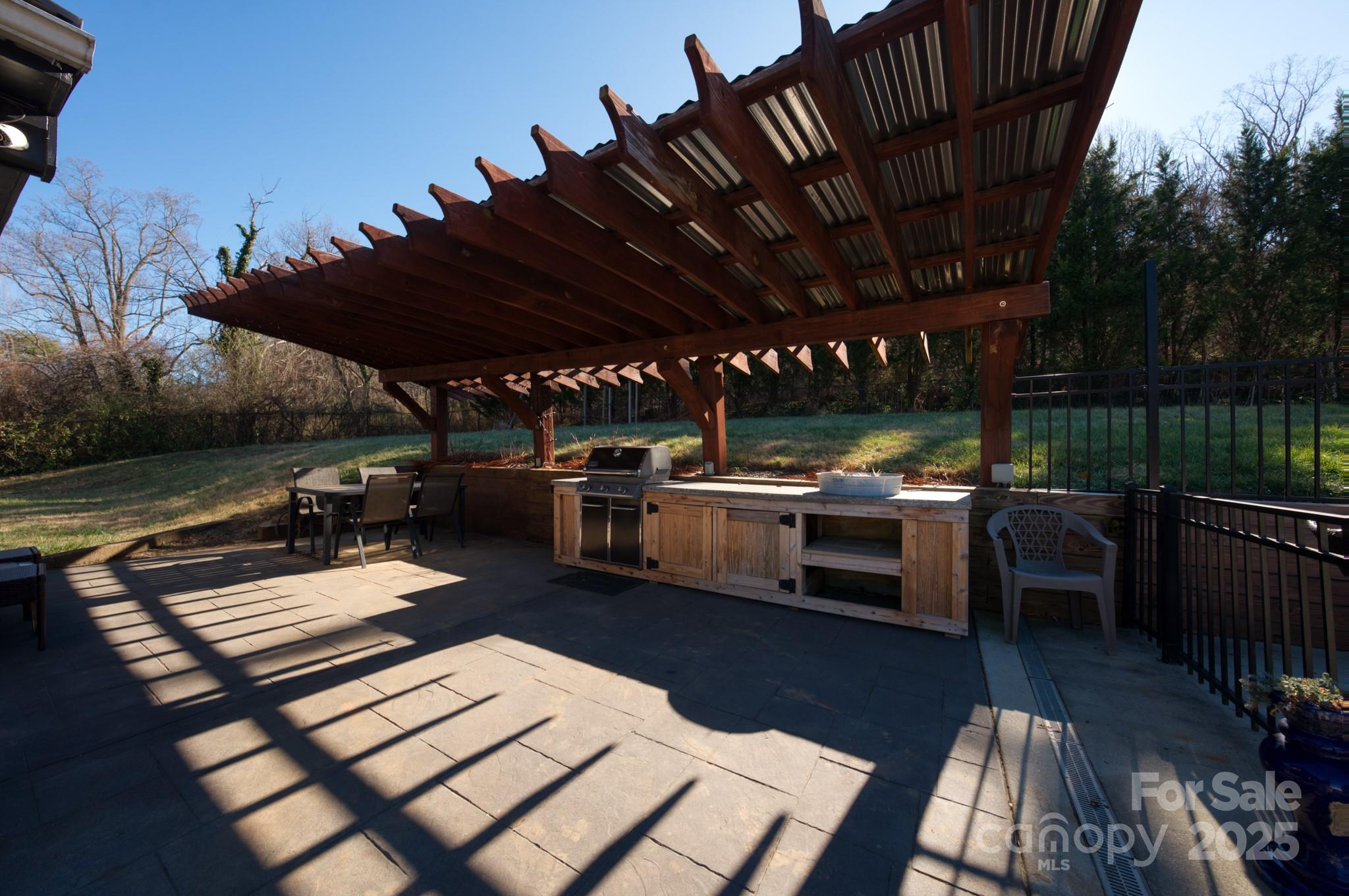 206 Martin Road Swannanoa, NC 28778 - Photo 28 of 42 a view of a patio with table and chairs with wooden floor and fence