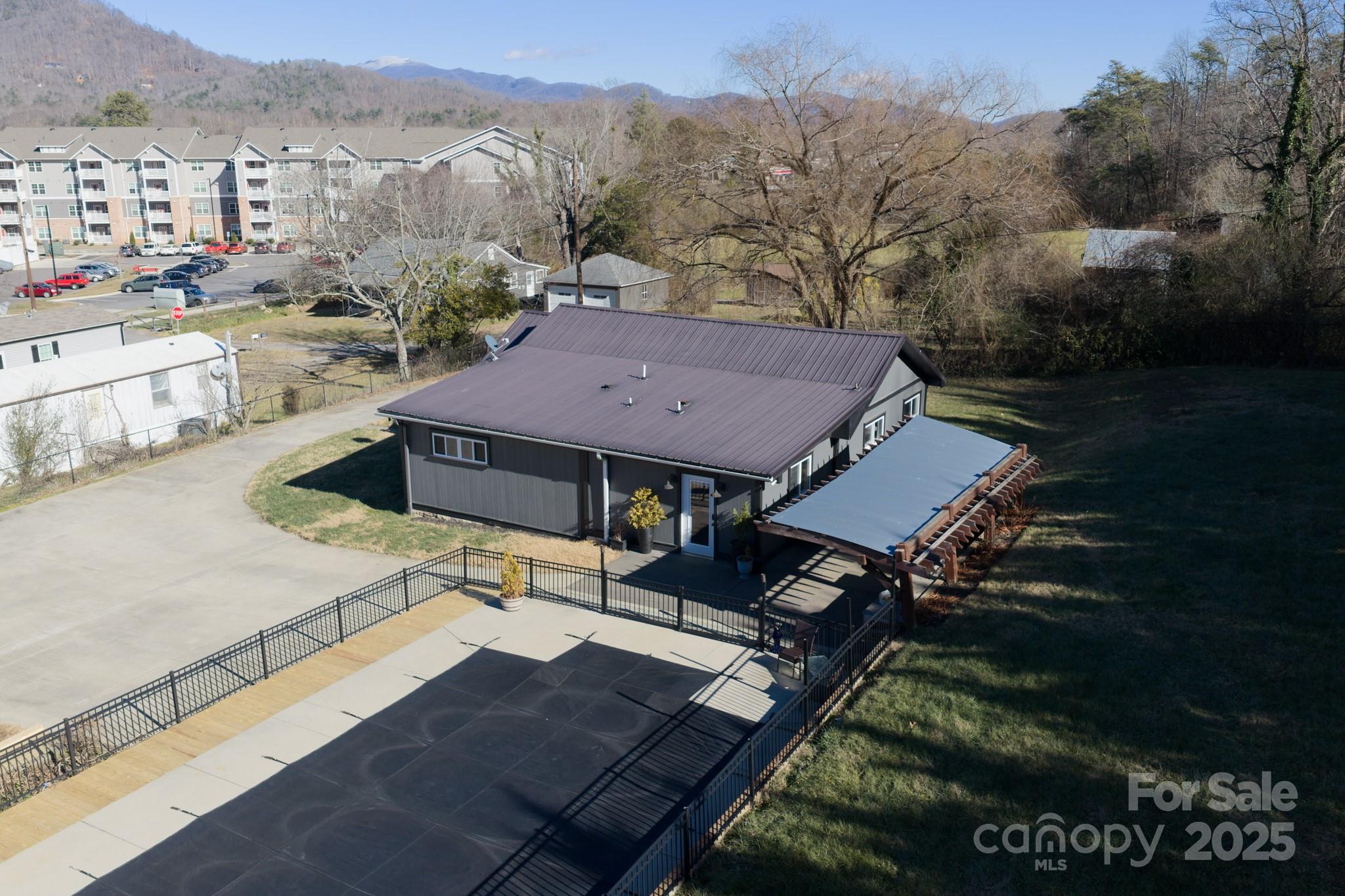 206 Martin Road Swannanoa, NC 28778 - Photo 4 of 42 a view of a patio with table and chairs and potted plants