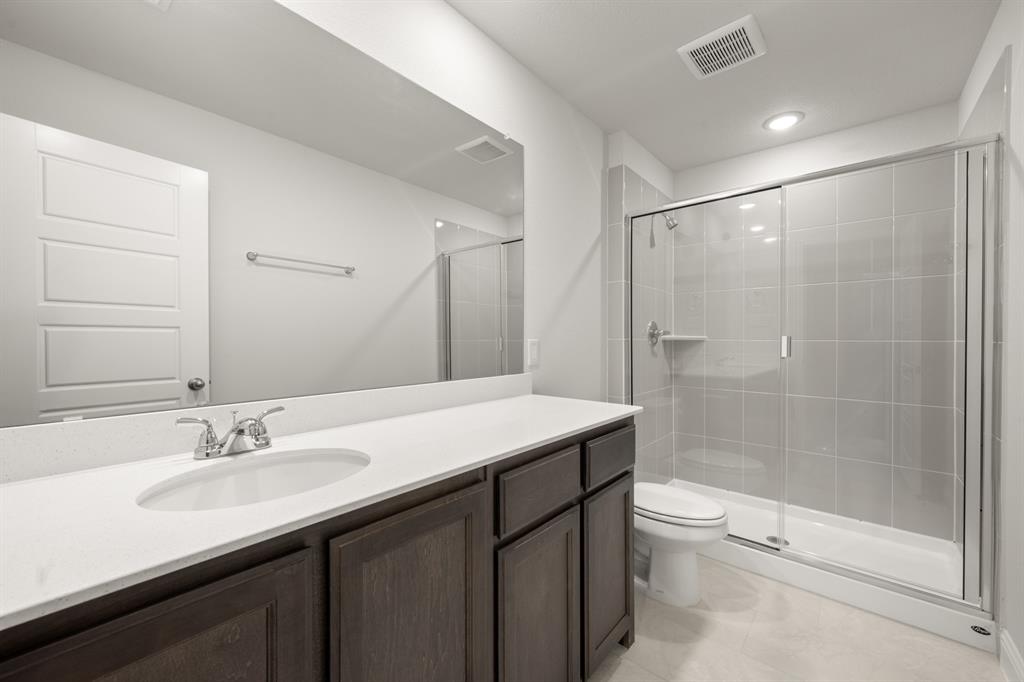 228 Shepards Street Godley, TX 76044 - Photo 24 of 27 a bathroom with a sink a toilet and shower