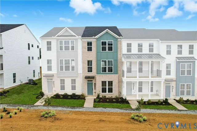 a front view of a residential apartment building with a yard