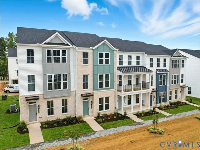 a front view of a residential apartment building with a yard