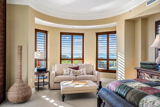 a bedroom with furniture and a large window