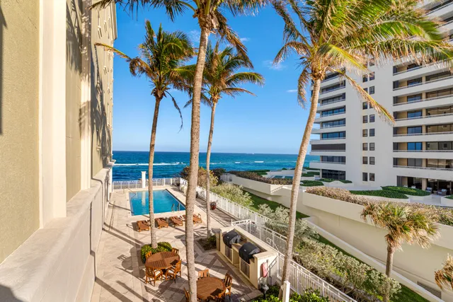 a view of balcony with two chairs and a table