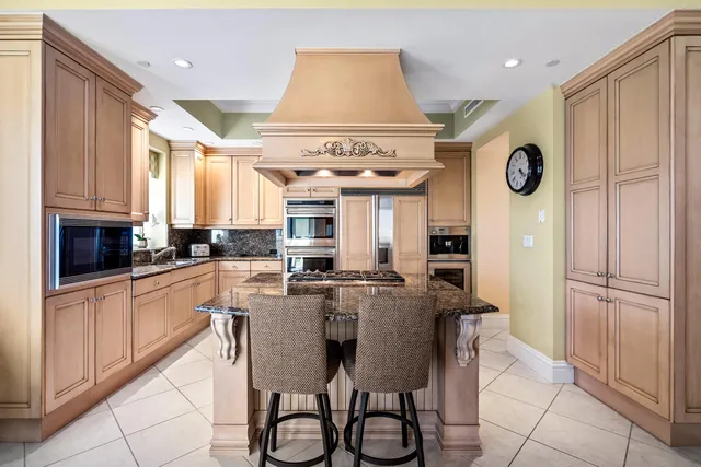 a kitchen with stainless steel appliances granite countertop a stove and a refrigerator