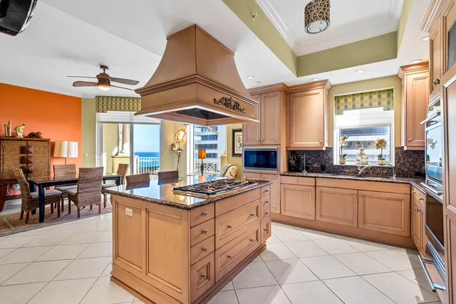 a kitchen with stainless steel appliances granite countertop a stove a sink and a microwave