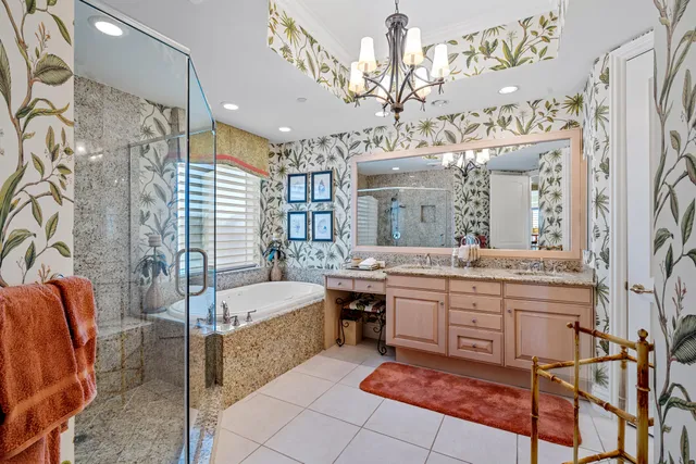 a large spacious bathroom with a sink a large mirror and a bathtub