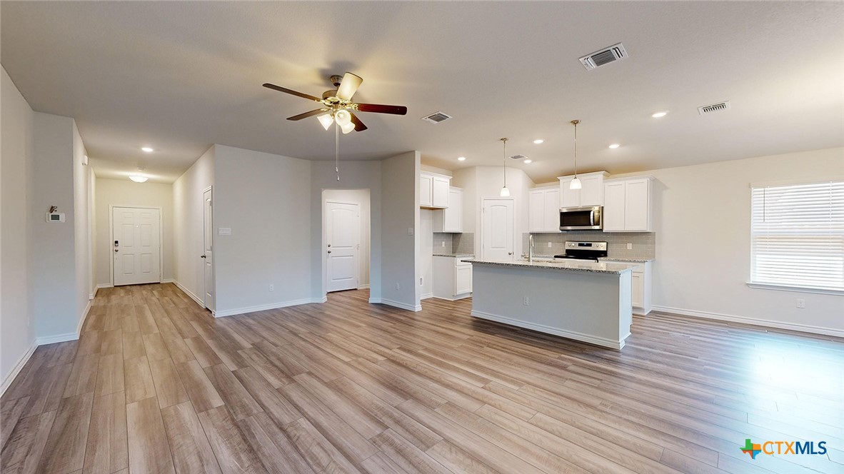 2057 Buckner Street Nolanville, TX 76559 - Photo 11 of 33 a view of kitchen with refrigerator microwave and stove