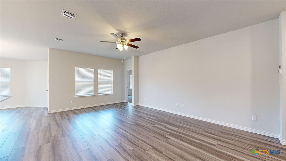 2057 Buckner Street Nolanville, TX 76559 - Photo 14 of 33 an empty room with wooden floor and windows
