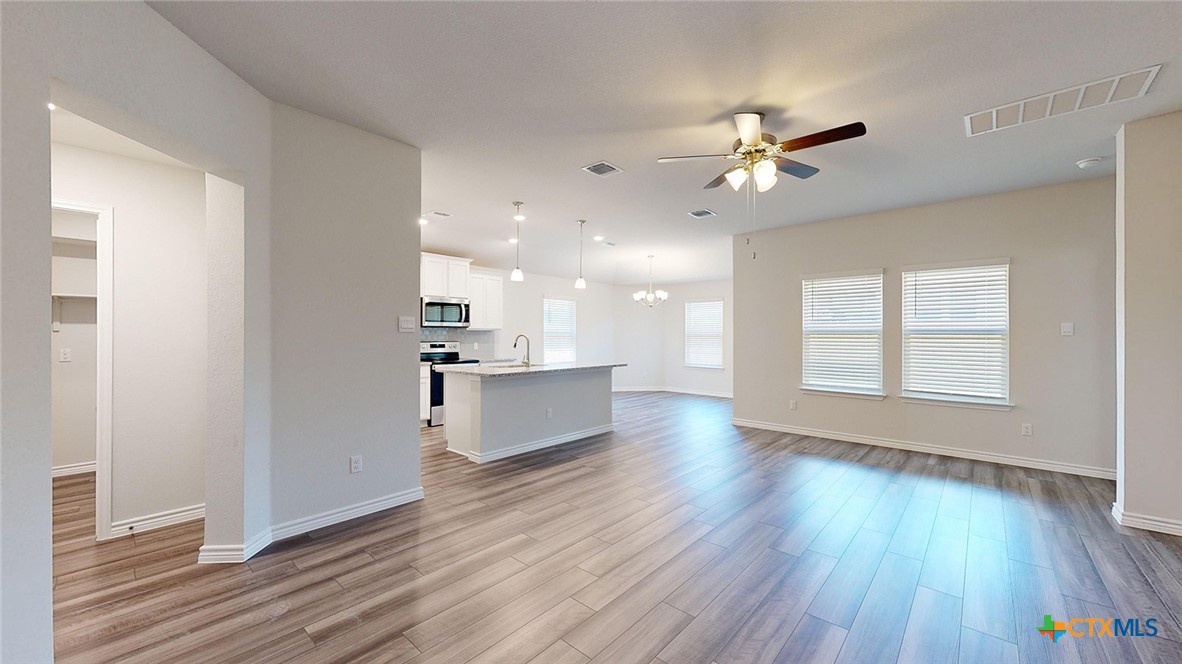 2057 Buckner Street Nolanville, TX 76559 - Photo 3 of 33 a view of a kitchen with wooden floor and a kitchen