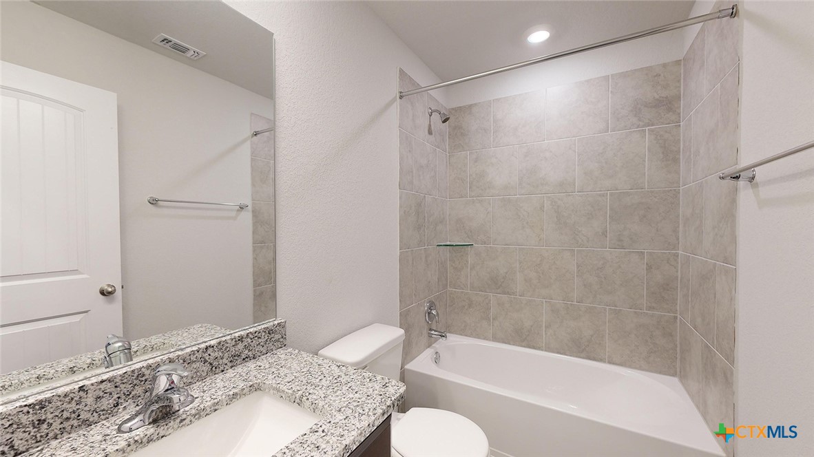 2057 Buckner Street Nolanville, TX 76559 - Photo 32 of 33 a bathroom with a granite countertop bathtub shower sink and toilet
