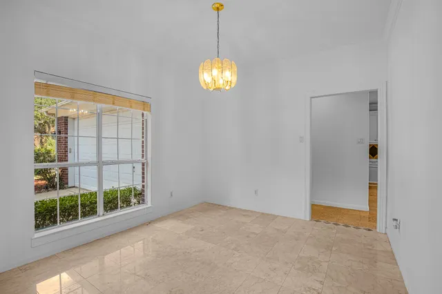 a view of a hallway with wooden floor and windows